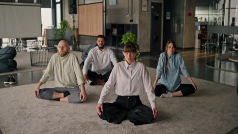 employees meditating in office