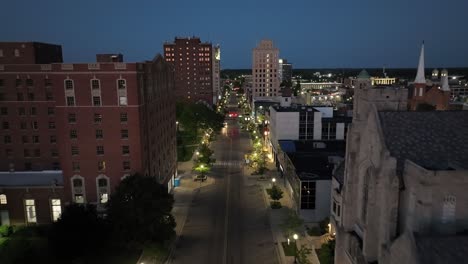 Jackson,-Michigan-downtown-at-night-with-drone-video-close-up-of-buildings-moving-forward