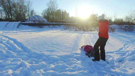winter family concept. mother and daughter have snow fun in slow motion