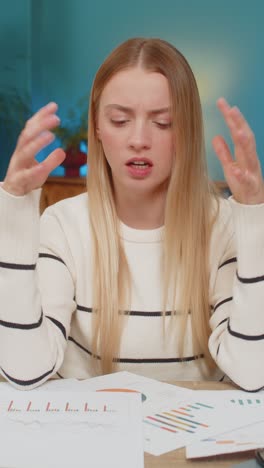 caucasian woman frustrated with bill errors at home on table holding documents feeling bankrupt