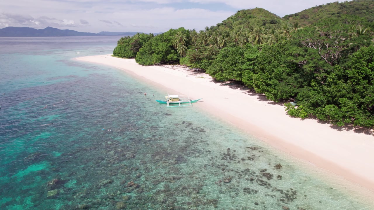 Aerial View of Boat on Beach With White Sand and Green Rainforest. Iloc Island, Philippines