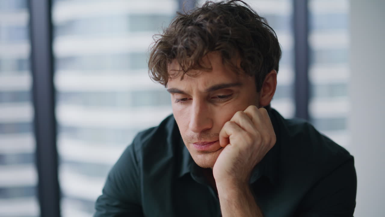 Overworked entrepreneur drinking coffee unmotivated to work at office closeup