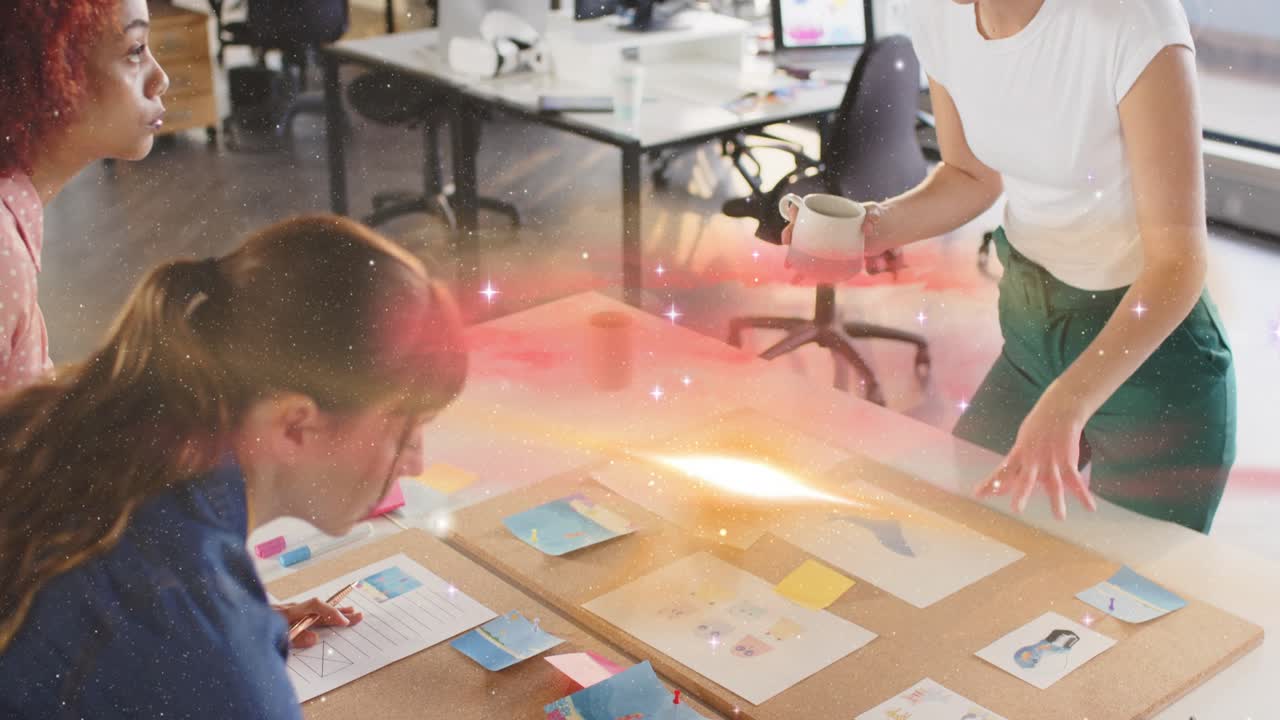 Hands reaching, design team grouping sticky notes for planning while overlay flowing across table