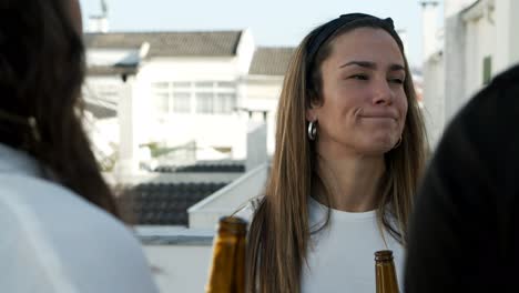 thoughtful young woman with beer bottle