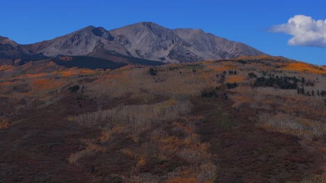mount sopris mountain valley peak from aspen old snowmass village el jebel basalts panorama landscape aerial drone colorado fall autumn foliage aspen trees forest blue sky clouds forward pan up motion
