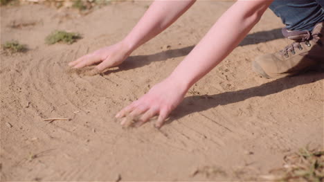 farmer touching dirt in hands pouring organic soil