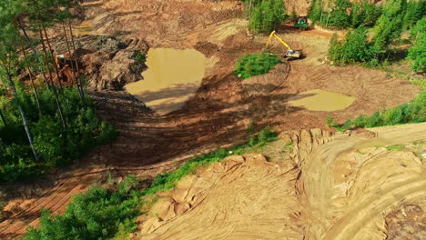 excavators working in the middle of large green forest