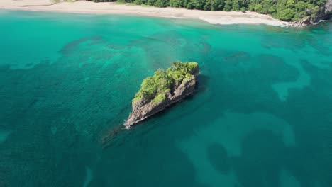 aerial orbit showcasing isla cocles surrounded by vibrant turquoise waters and pristine coastline in costa rica.