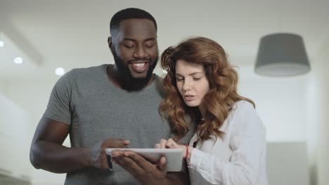 young couple talking at living room. man and woman discussing at kitchen.