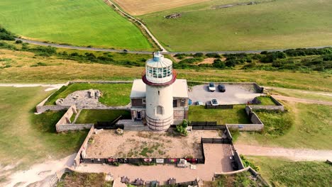 the belle tout lighthouse situated on the edge of the beautiful seven sisters chalk cliffs and stunning green fields