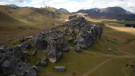 Castle-Hill-limestone-formations-and-Canterbury-mountain-landscape-aerial-panoramic,-New-Zealand