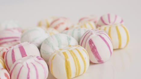 retro striped round candies on pile close-up 4k video