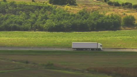 truck on highway through scenic landscape