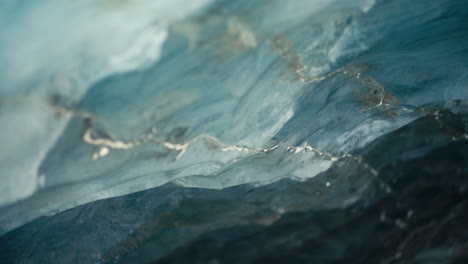 abstract blue ice formation in ice cave with cracks under a glacier tilt up