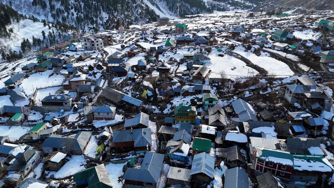 Aerial drone shot of Chitkul’s snow-draped mountains and valleys under a clear blue sky.