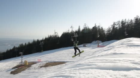 snowboarder-spinning-a-540-with-a-nose-grab-over-a-large-jump-in-the-snow-park