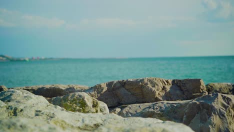 Nature-Sea-Ocean-River-Shore-Stones-Rocks-Waves-Ripple-Sunny-Sunset-Daylight-Blue-Sky-Clowds-Portugal-Tejo-Boat-Ship-Oil-Tanker-Steady-Shot-4K