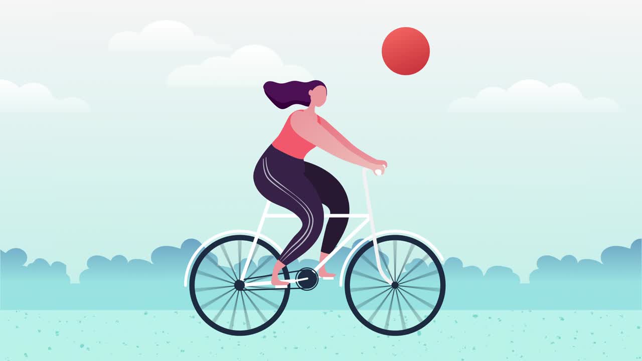 A woman is riding a bicycle on the street in the park. Healthy lifestyle