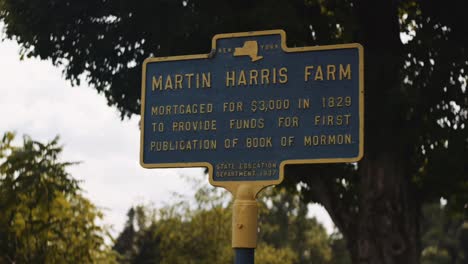Dpan across a sign to Martin Harris farm in Downtown Palmyra New York
