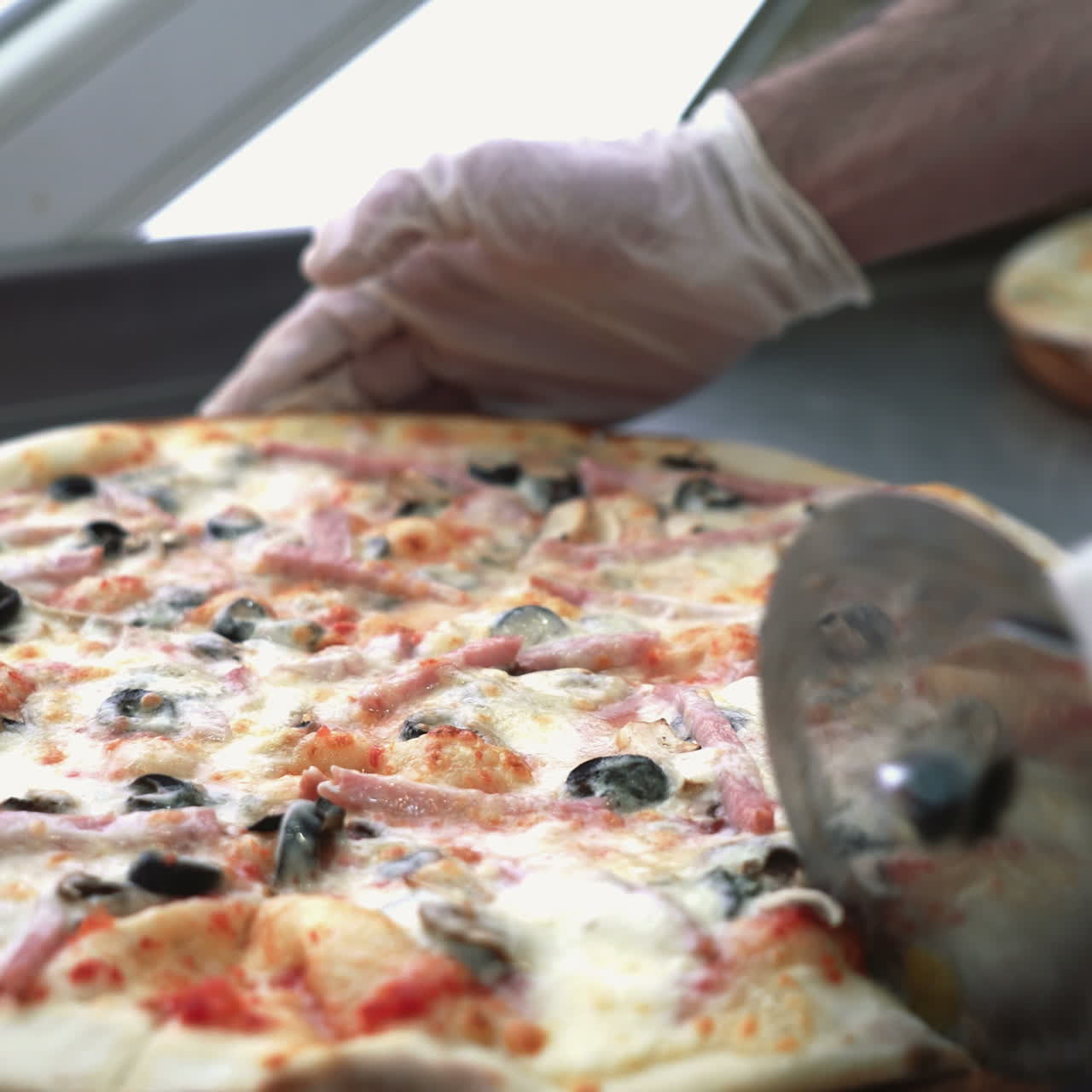 Chef cuts freshly prepared pizza slices Sqare video