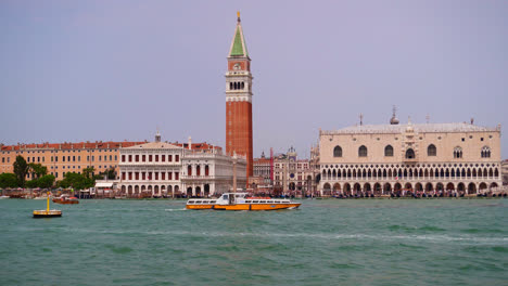 ferry crossing the lido di venezia in front of saint mark's square in venice, italy - wide