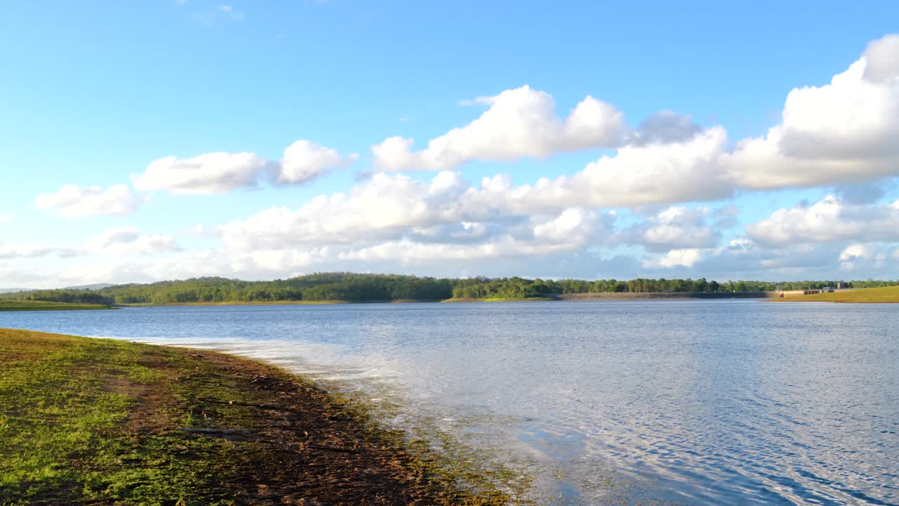 Majestic time-lapse of lake with Dam in the distance