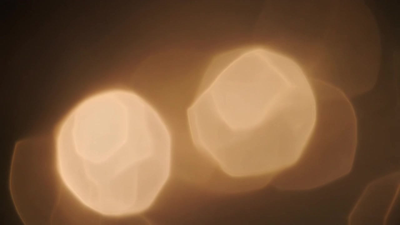 Abstract Golden Bokeh Light Leaks on Dark Background