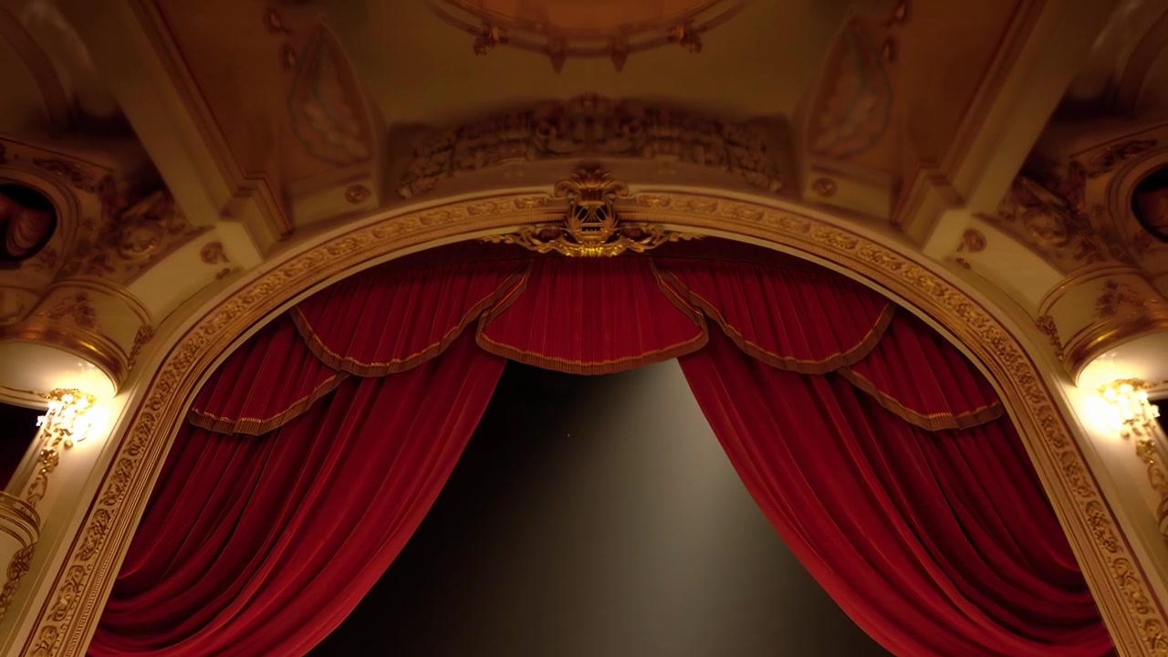 Elegante escenario de teatro con cortinas rojas y un foco brillante