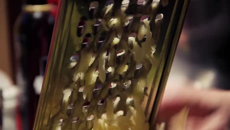 a close up of a potato being grated at night