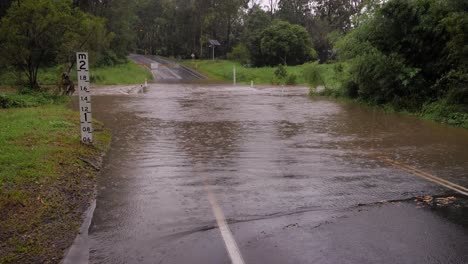 Gold-Coast,-Queensland,-16-February-2024---Flooding-across-Hardy's-Road-in-Mudgeeraba-after-heavy-rains-continue-to-lash-South-East-Queensland,-Australia