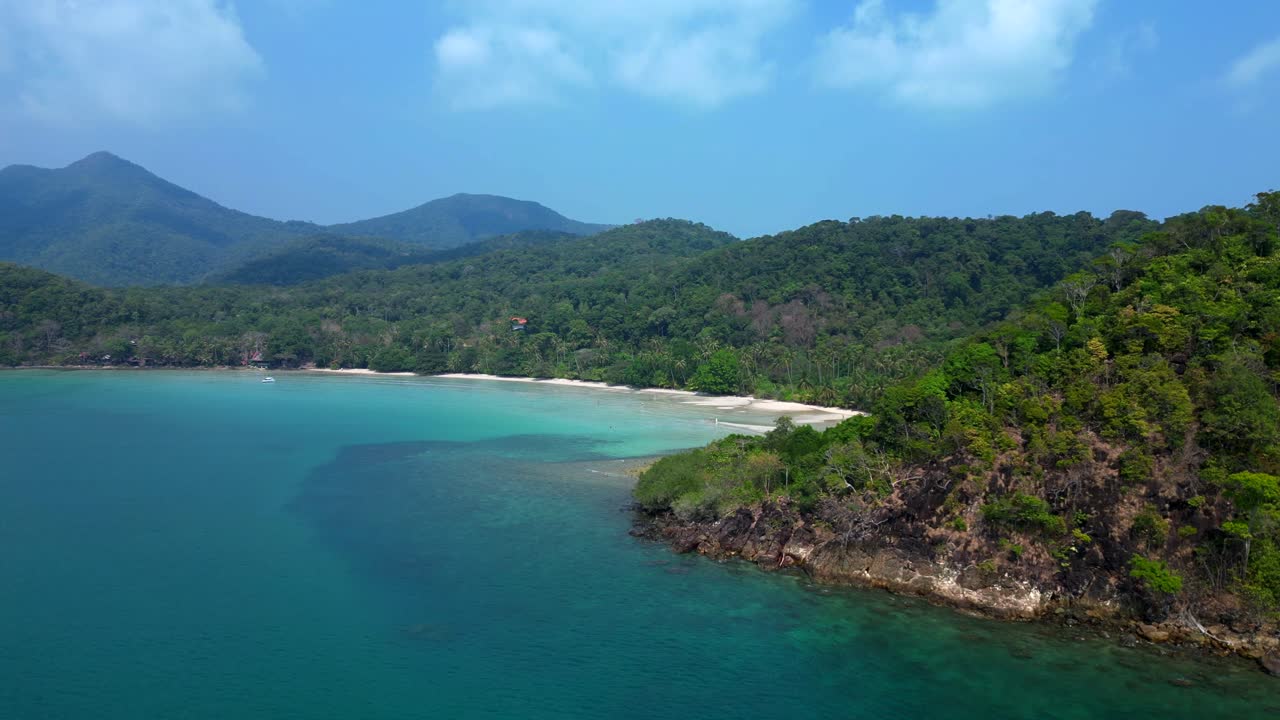 ong beach at koh chang island showing turquoise water and green rainforest in Trat Province, Thailand. Dramatic aerial view flight speed ramp hyper motion time lapse