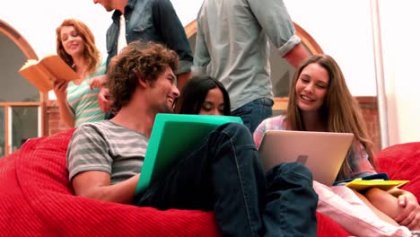 Happy-students-relaxing-in-common-room-