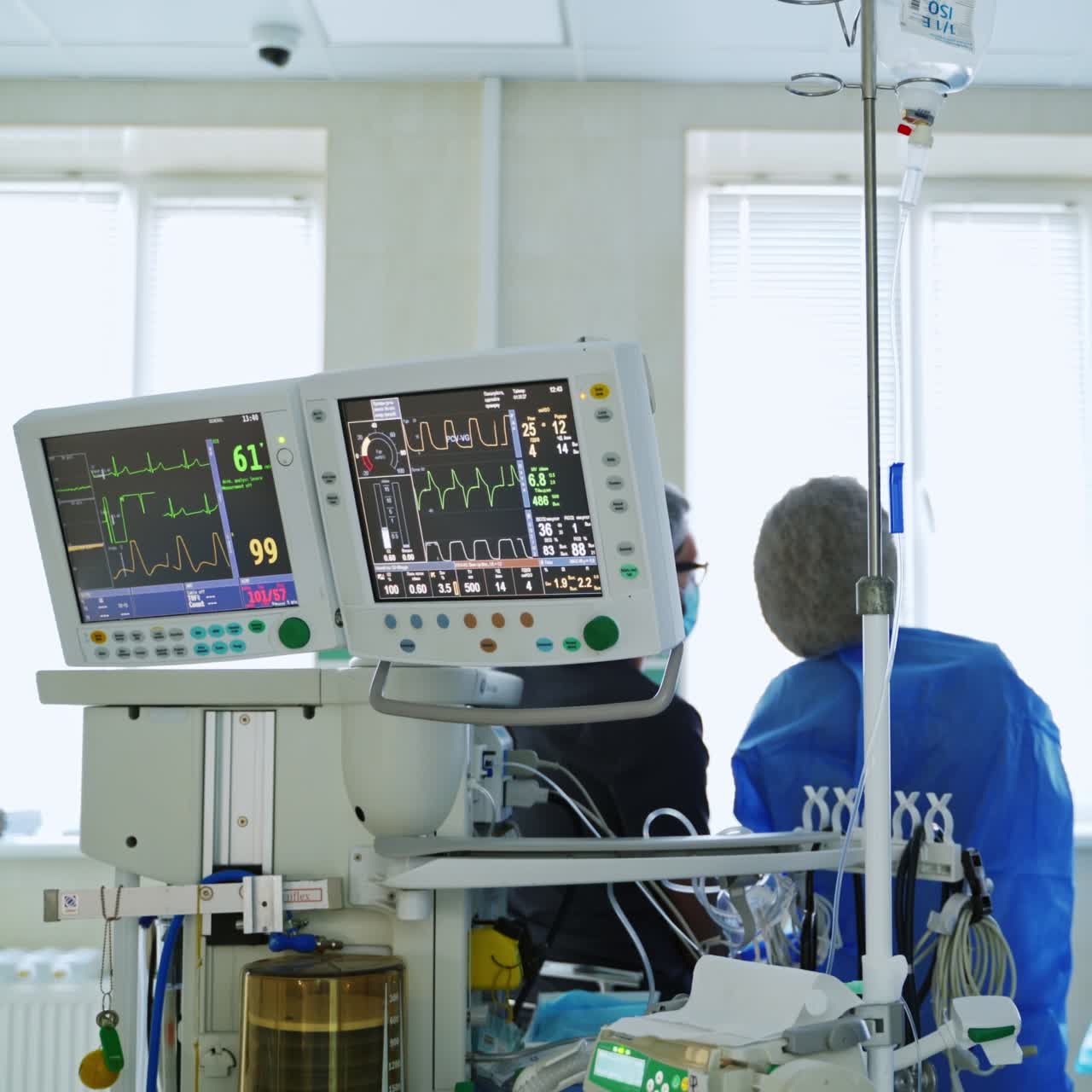 Modern equipment in the operating room in clinic. Medical workers look at the screen of a monnitor during robotic surgery.