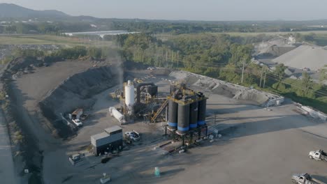 Static-aerial-footage-of-a-industry-site-with-smoke-and-oil-containers