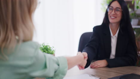 Woman-Signs-Loan-Agreement-and-Shakes-Hands