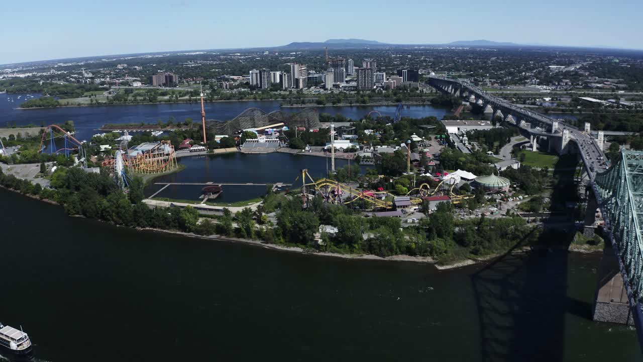 Aerial shot of the La Ronde theme park in Montreal, featuring thrilling rides and vibrant attractions. Captures the excitement and fun of the park with the city skyline in the distance.
