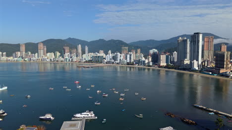 aerial view of meia praia beach with boats and itapema skyscrapers, brazil