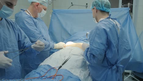 breast augmentation under the guidance surgeons team in surgical operating room