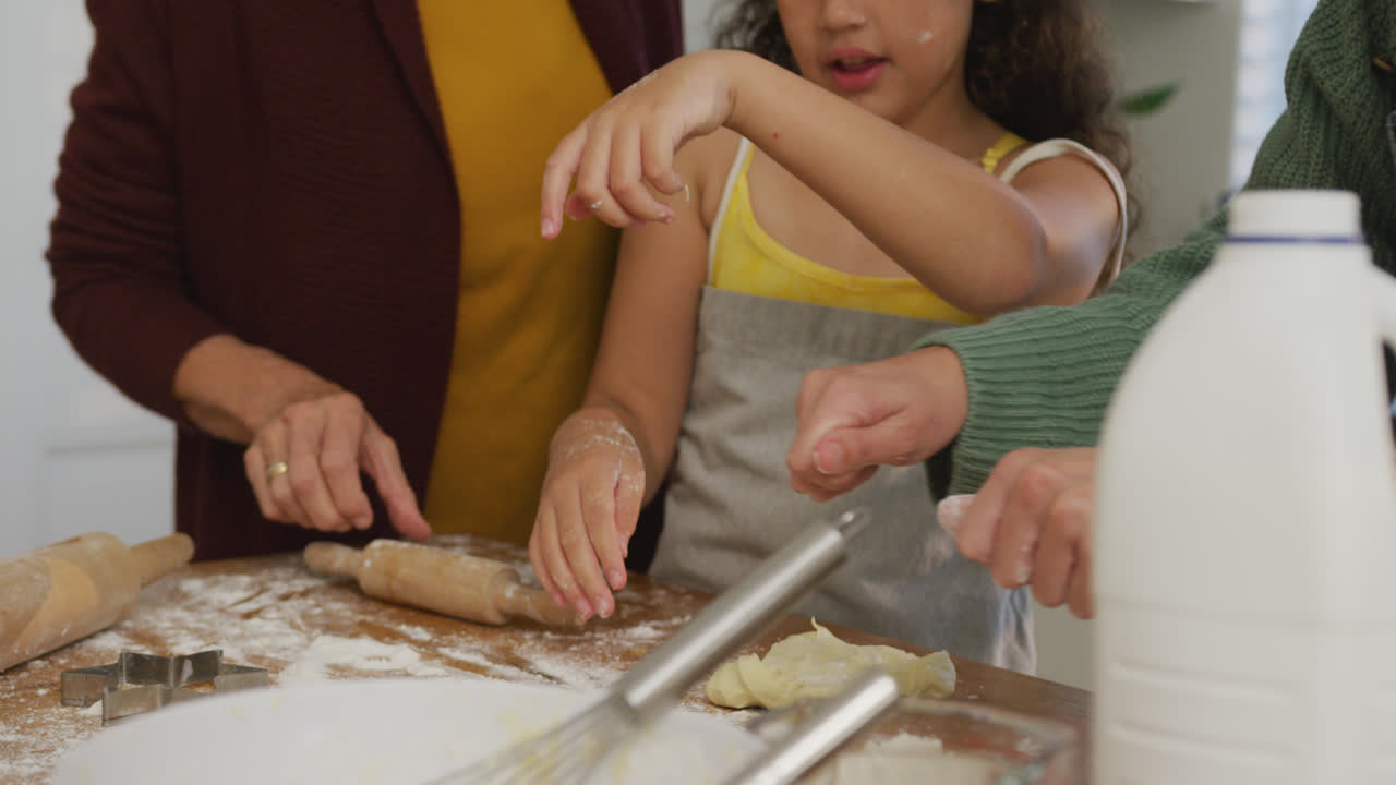 Video of biracial granddaughter and caucasian grandmother cooking together