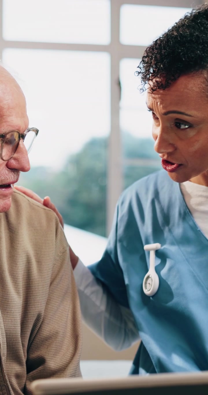 Nurse Explaining Medical Information to Senior Patient on Tablet