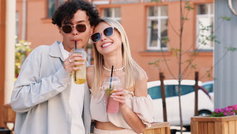 happy couple enjoying drinks outdoors