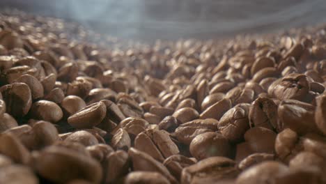 Close-up-of-seeds-of-coffee.-Fragrant-coffee-beans-are-roasted-smoke-comes-from-coffee-beans.