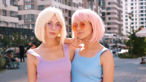 two women in colorful wigs and sunglasses