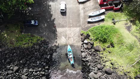 top-down drone footage of people stowing a boat