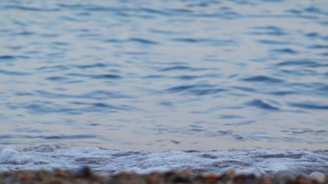 Close up of waves hitting the shore on the beach