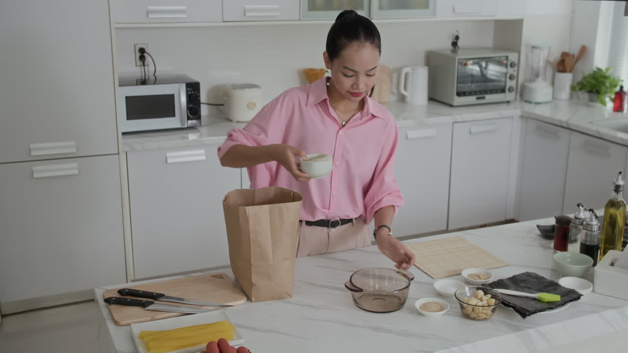 Female Zoomer Preparing Rice for Cooking Traditional Dish at Kitchen