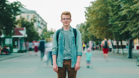 young man standing on city street
