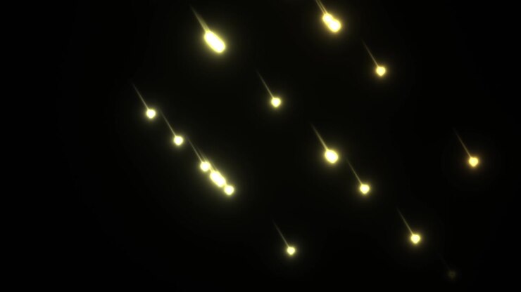 The scene shows small light particles falling steadily in a dark space. The lights create a glowing effect and add a dynamic element to the visual