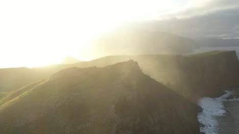 beautiful hazy sunshine over the green peninsula on the coast of madeira