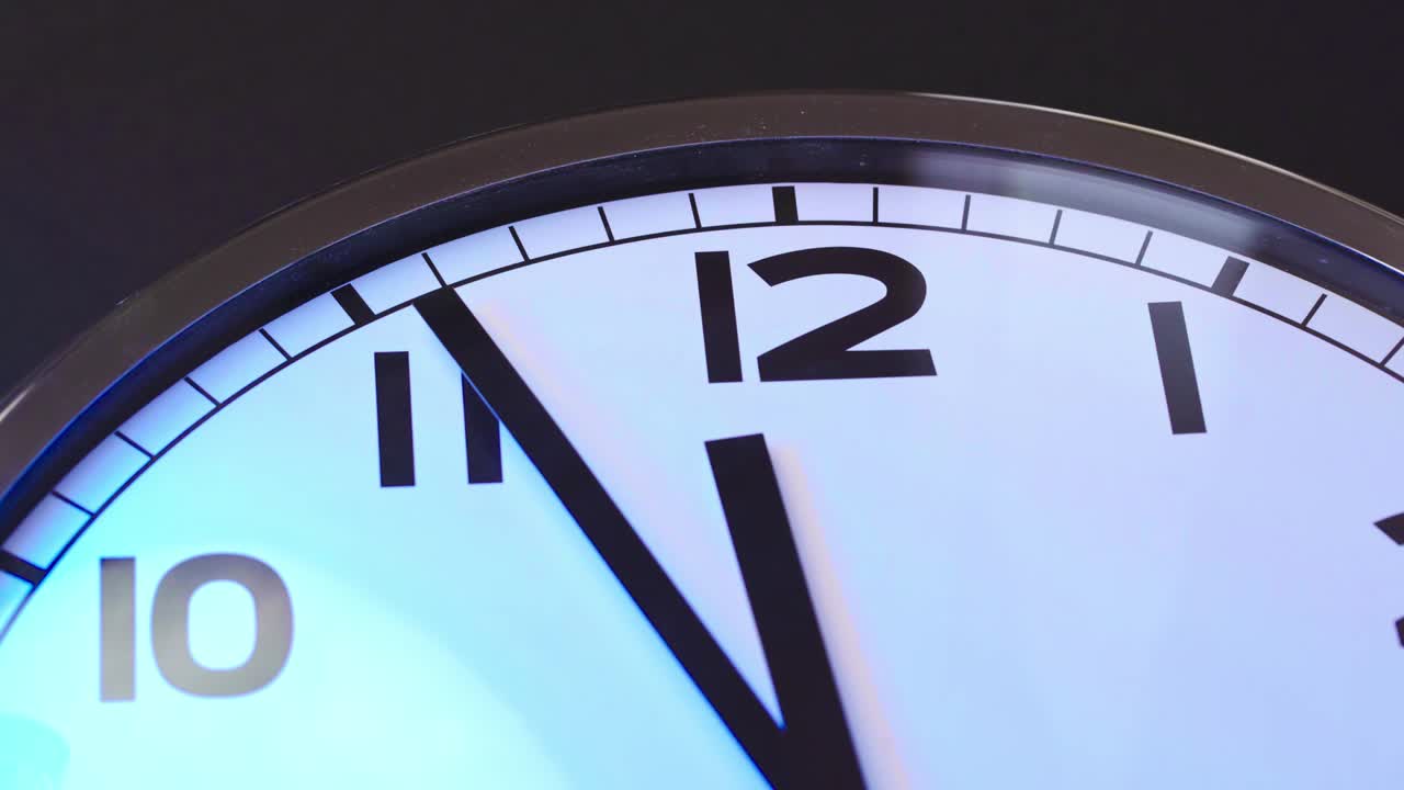 Close up video of clock face on wall